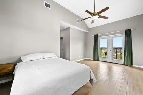 a bedroom with a large bed and a large window