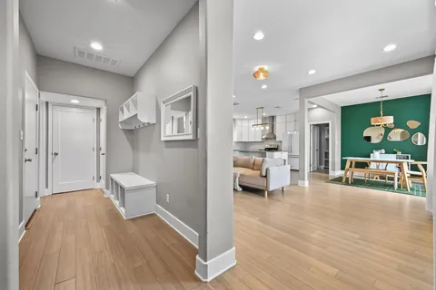 a living room with furniture and a wooden floor