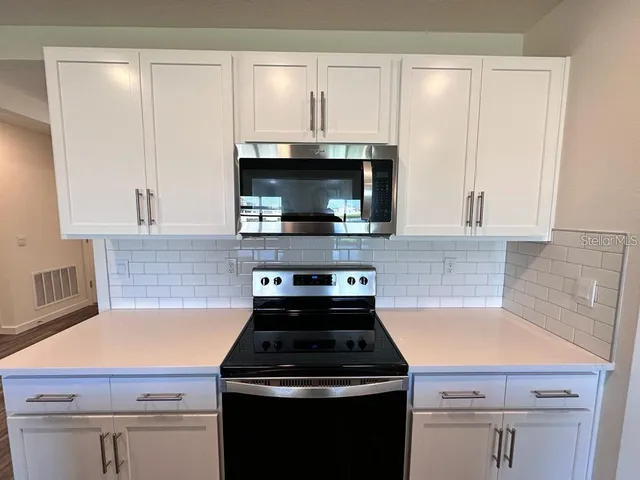 a kitchen with a stove and a microwave