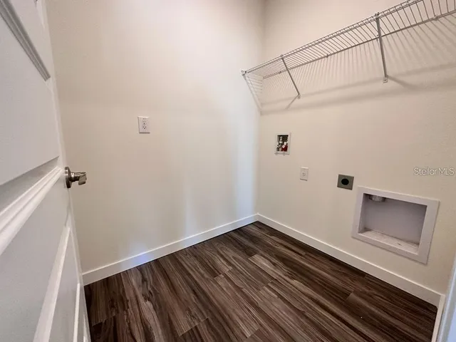 a room with a wooden floor and white walls