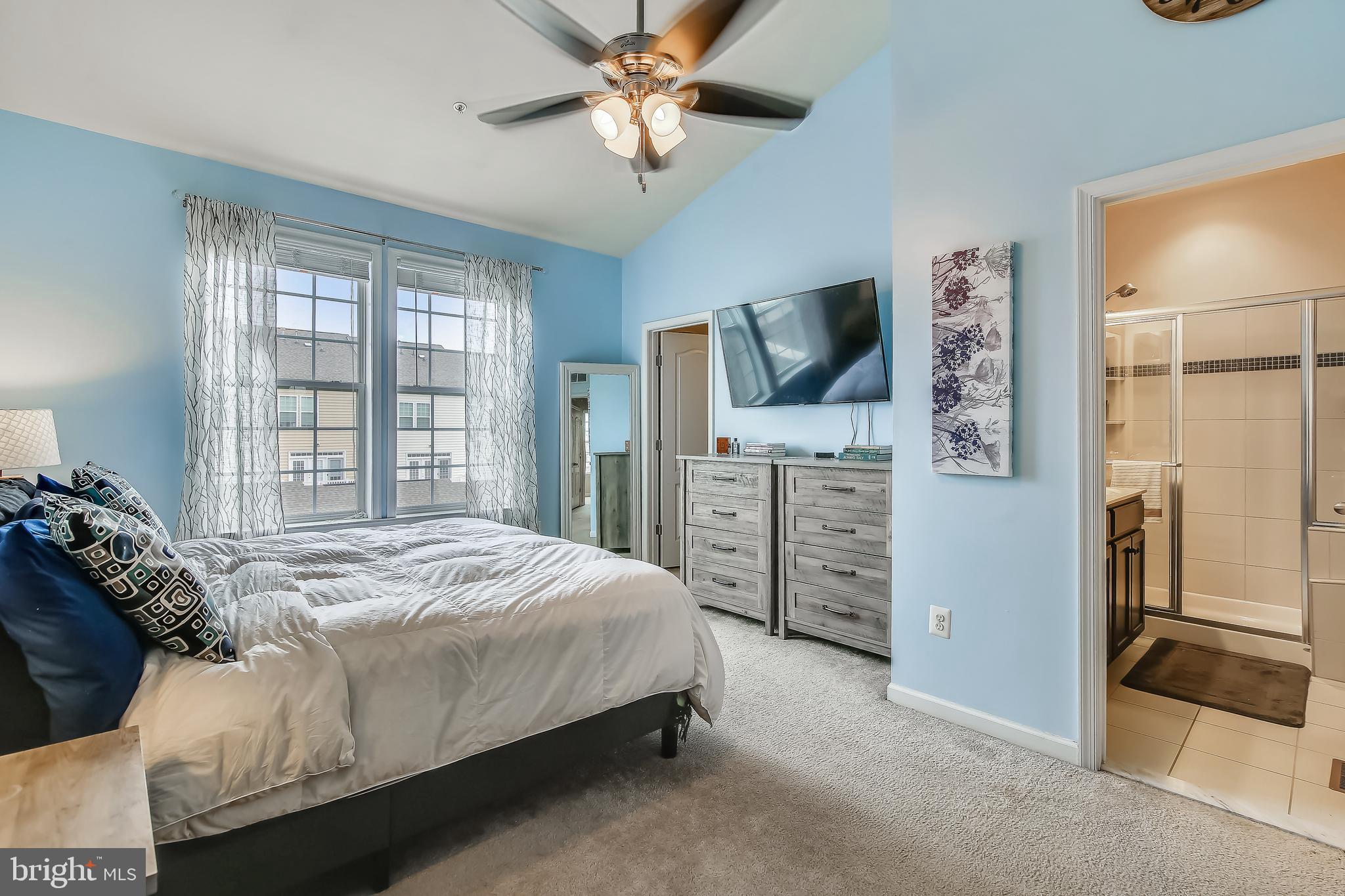 7855 Wormans Mill Road Frederick, MD 21701 - Photo 21 of 35 a bedroom with a bed and a flat tv screen on dresser