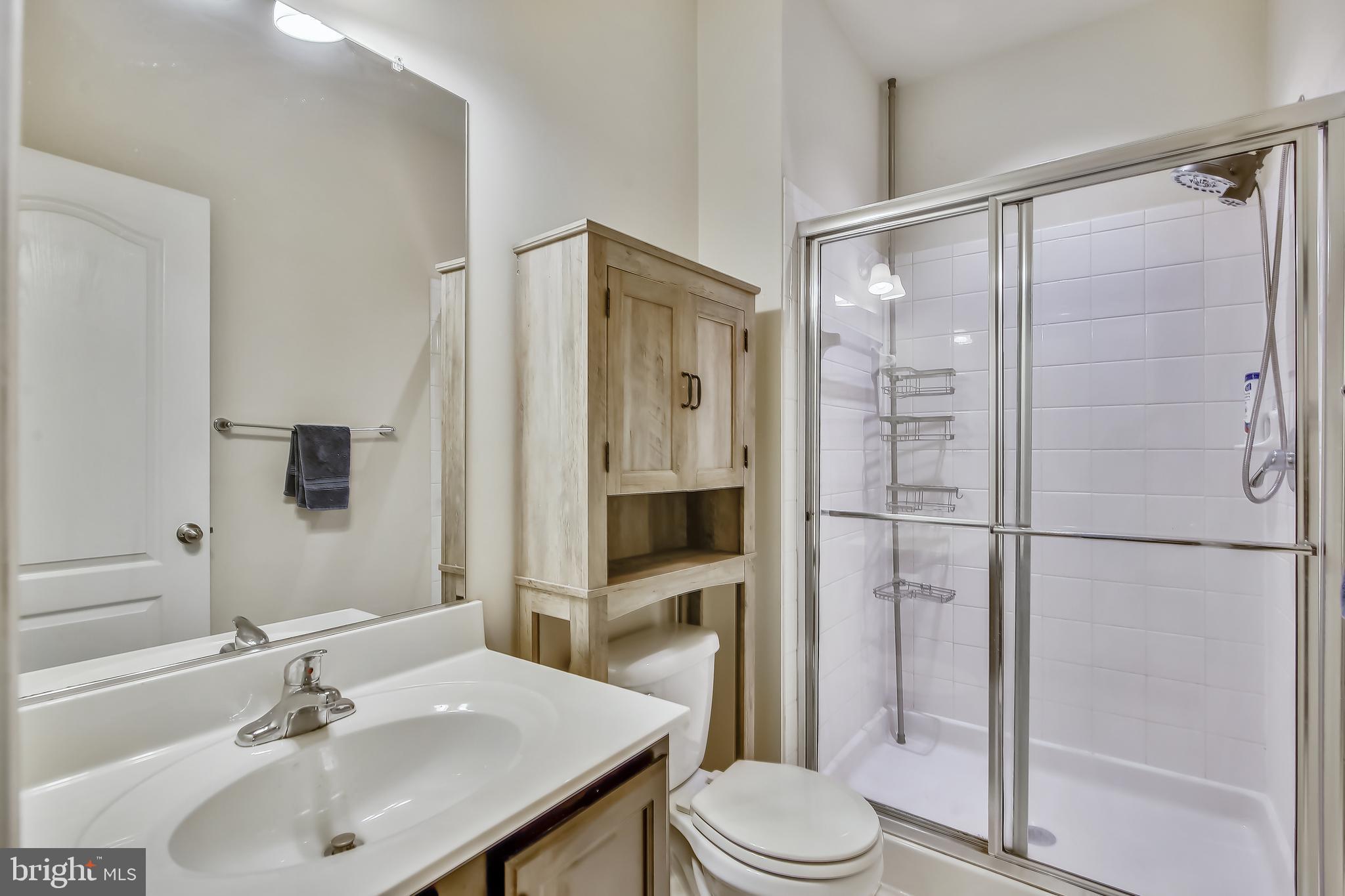 7855 Wormans Mill Road Frederick, MD 21701 - Photo 8 of 35 a bathroom with a sink toilet and shower