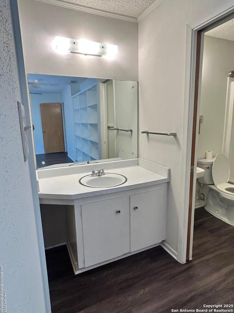 811 Jackson Keller Road, Unit 8 San Antonio, TX 78216 - Photo 16 of 19 a bathroom with a sink and mirror
