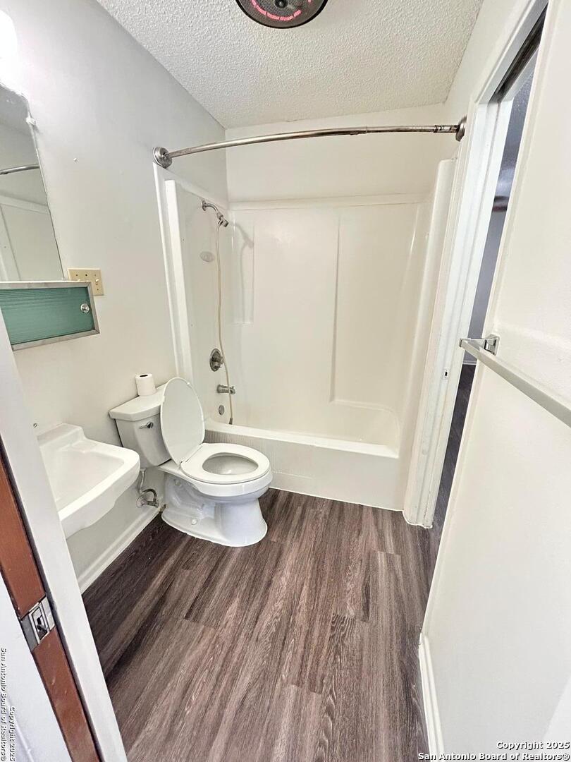 811 Jackson Keller Road, Unit 8 San Antonio, TX 78216 - Photo 17 of 19 a bathroom with a toilet a sink and a shower