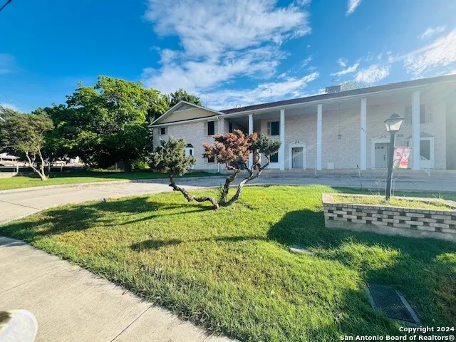 a view of a house with swimming pool and a yard