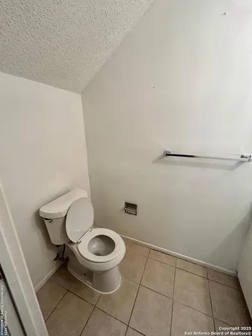 a white toilet sitting next to a shower
