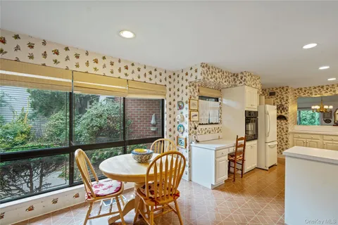 a balcony with table and chairs