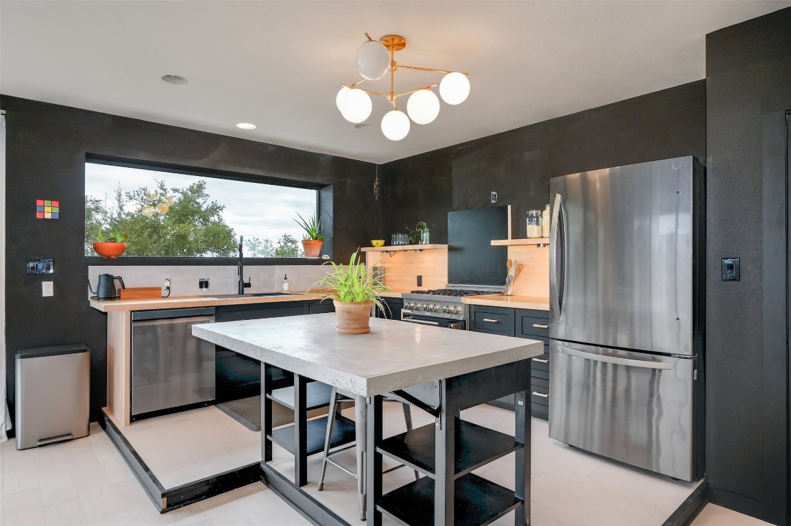 640 Ghost Dancer Fischer, TX 78623 - Photo 14 of 40 a kitchen with stainless steel appliances granite countertop a refrigerator a sink a stove and a refrigerator