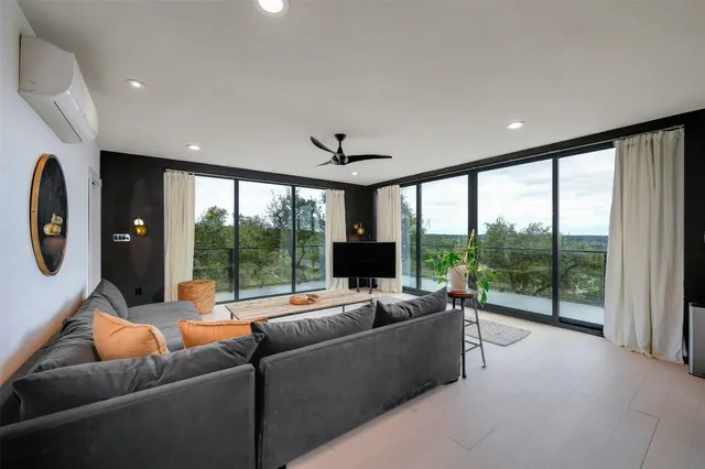 a living room with furniture and a large window