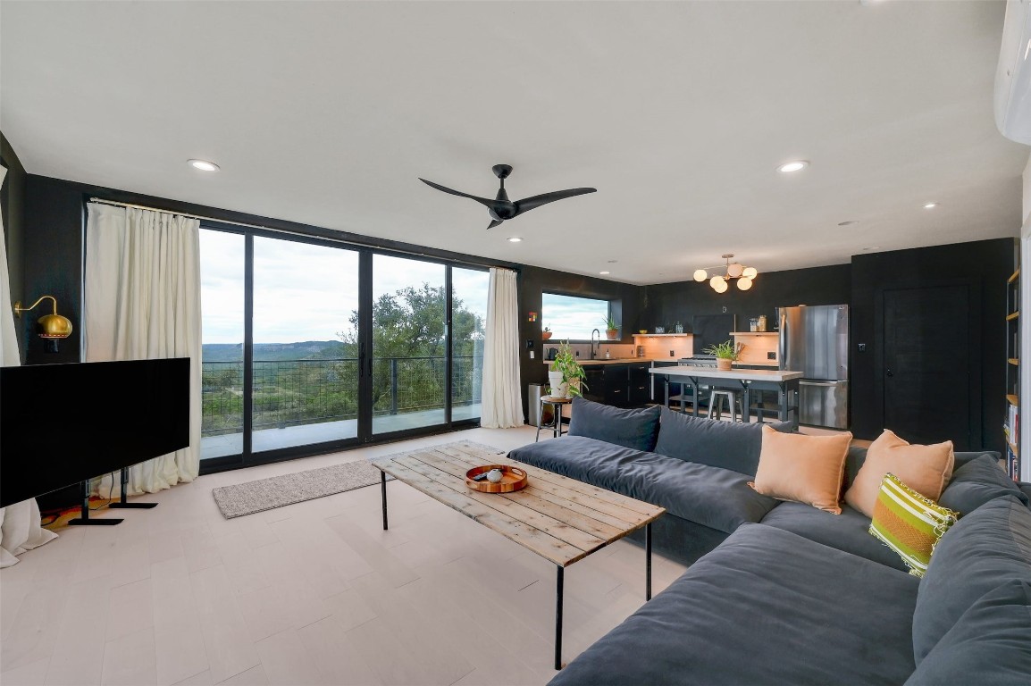 640 Ghost Dancer Fischer, TX 78623 - Photo 18 of 40 a living room with furniture a flat screen tv and a large window