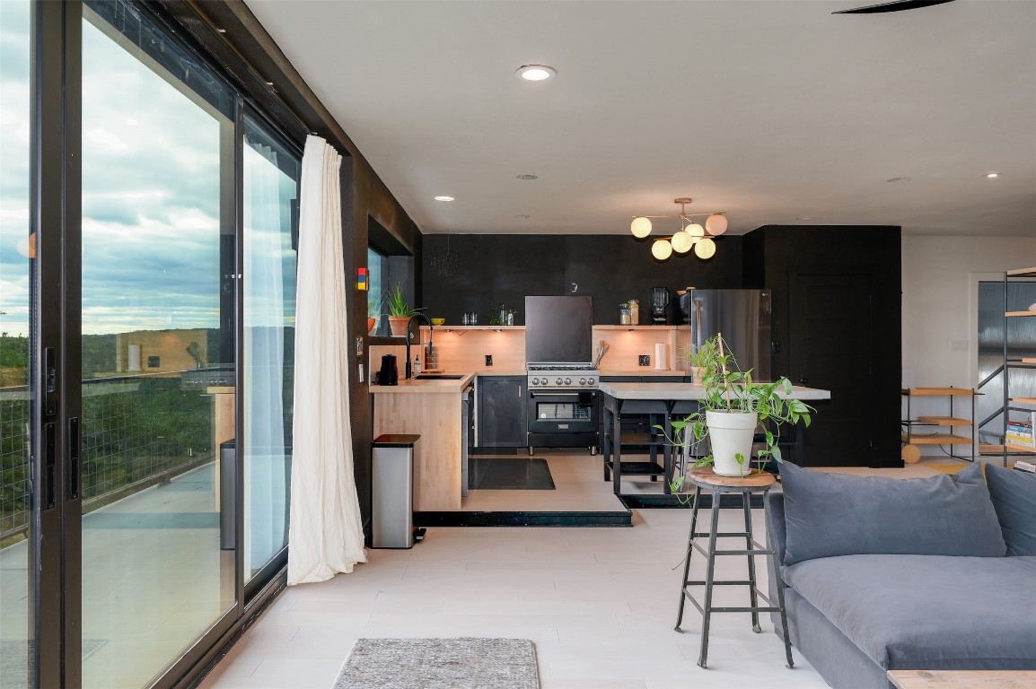 640 Ghost Dancer Fischer, TX 78623 - Photo 19 of 40 a living room with furniture a chandelier and a large mirror