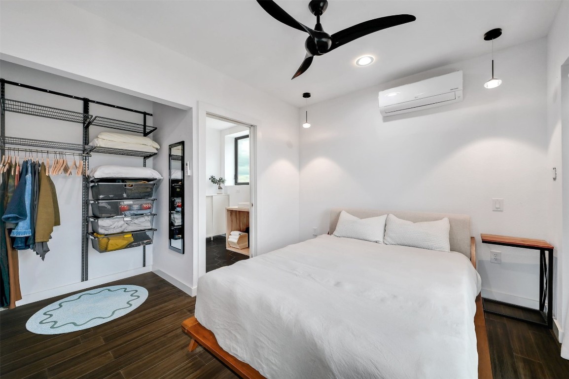 640 Ghost Dancer Fischer, TX 78623 - Photo 20 of 40 a bedroom with a large bed and a chandelier