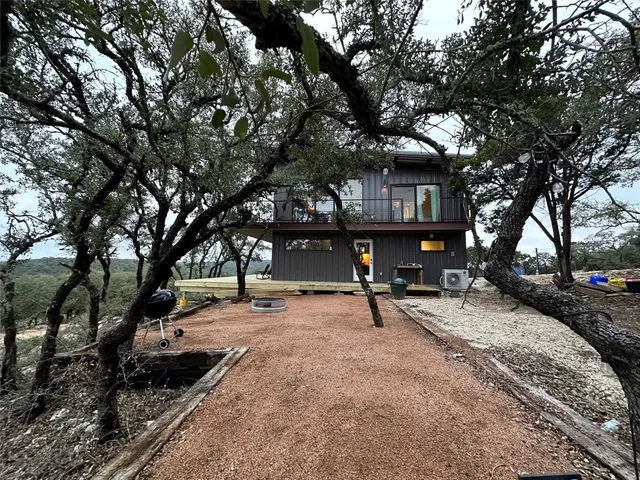 a view of a house with backyard and sitting area