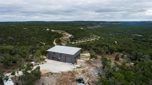 an aerial view of a house with a yard