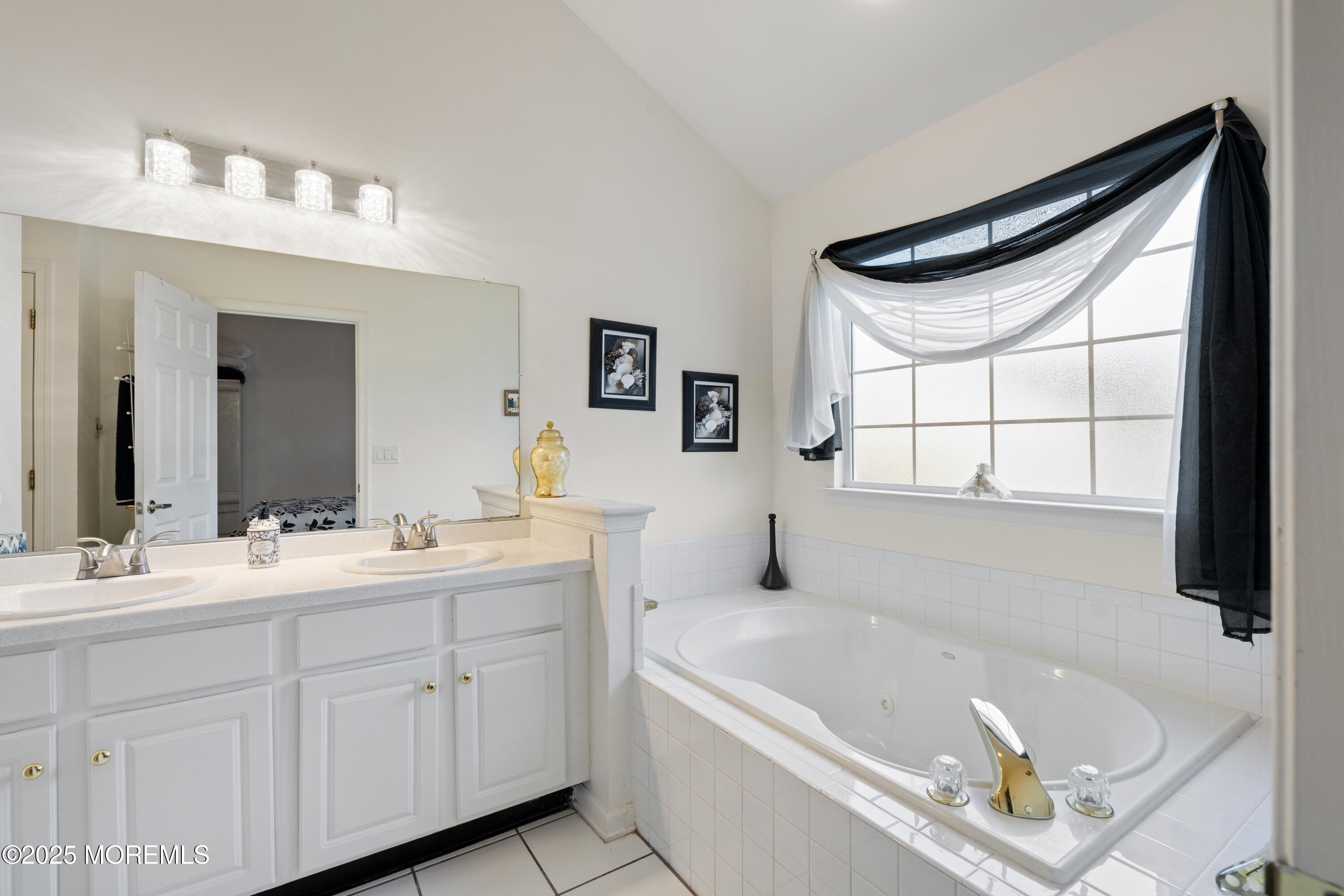 7 Regent Square Jackson, NJ 08527 - Photo 13 of 29 a bathroom with a tub a double vanity sink a window and a mirror
