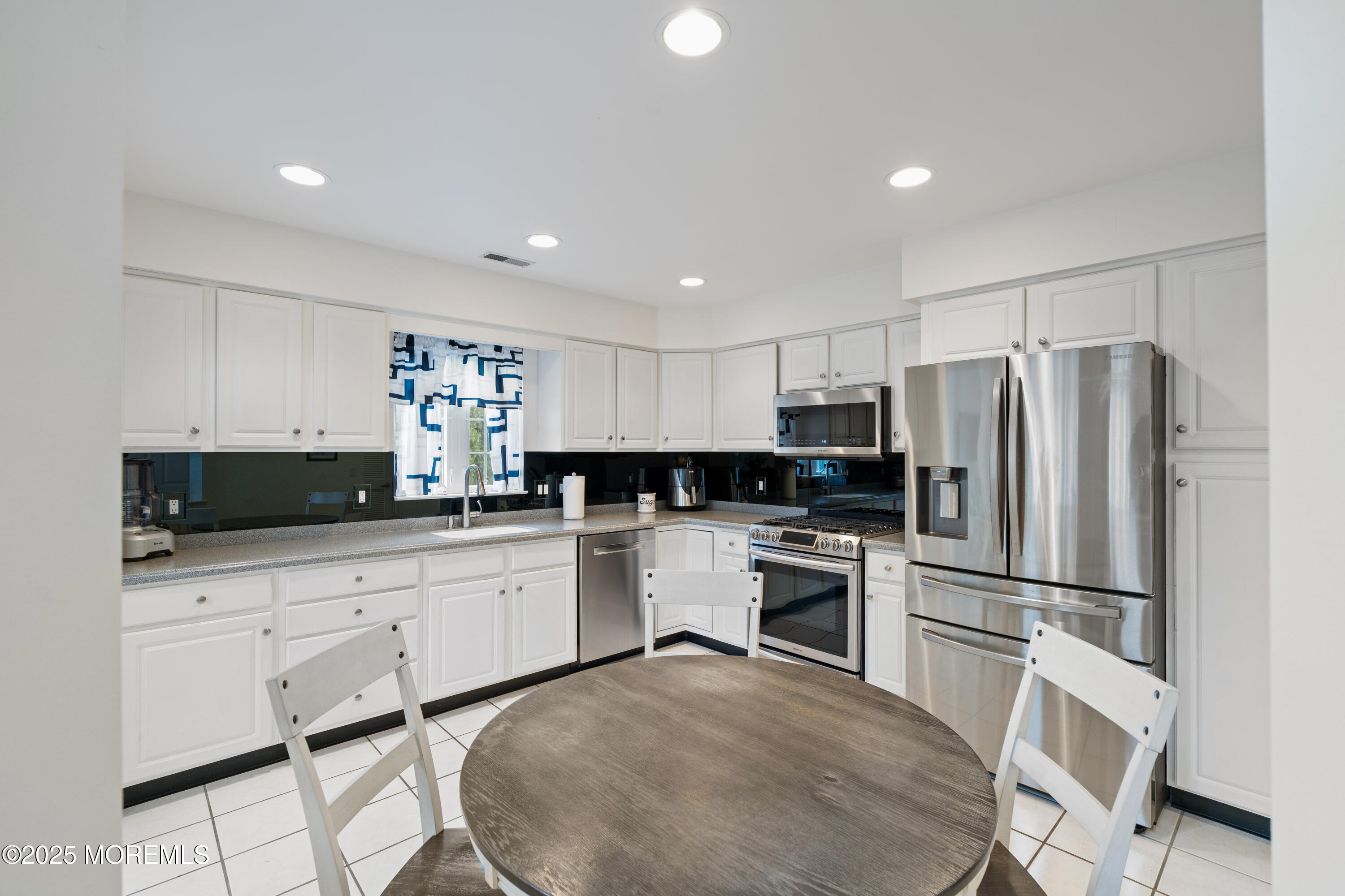 7 Regent Square Jackson, NJ 08527 - Photo 2 of 29 a kitchen with white cabinets and stainless steel appliances