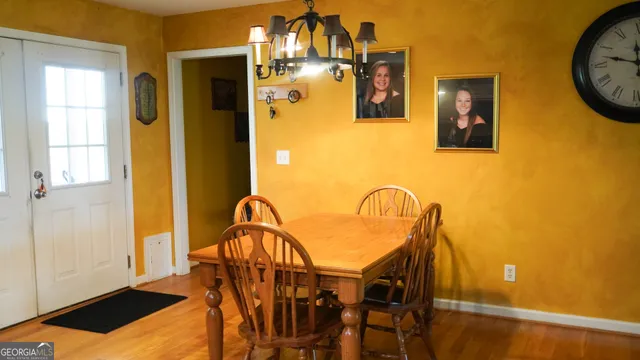 a dining room with furniture and a window