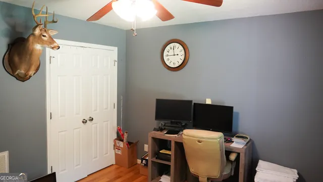 a view of a workspace with furniture and wooden floor