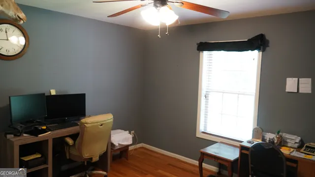 a view of a workspace with furniture and a window