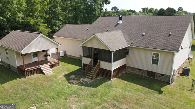 a aerial view of a house with a yard balcony and sitting area