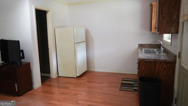a view of room with walk in closet and wooden floor
