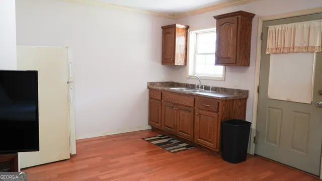 a kitchen with a sink a stove and a refrigerator