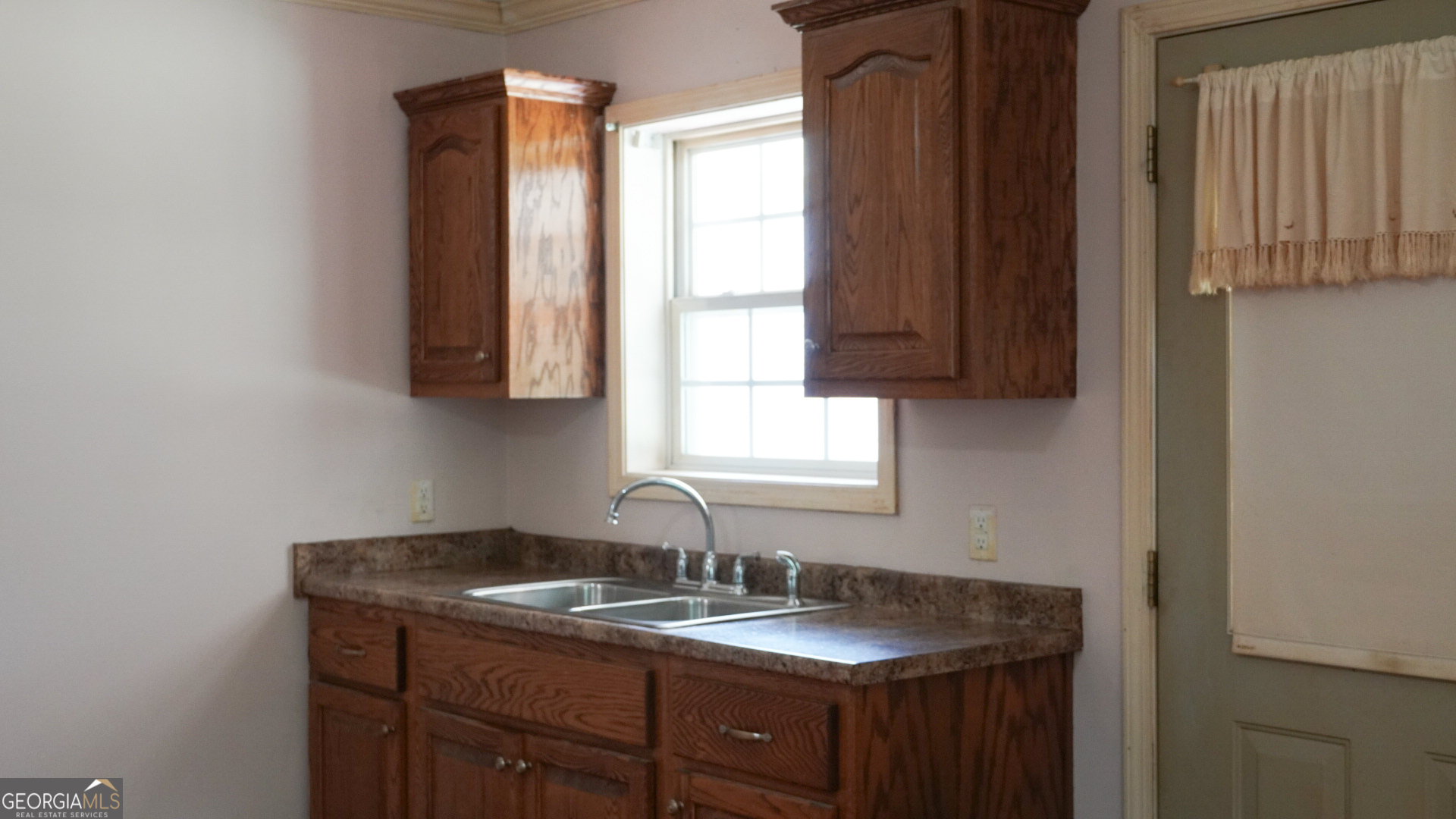 1881 Beeks Road Williamson, GA 30292 - Photo 23 of 32 a kitchen with a granite countertop sink and a window