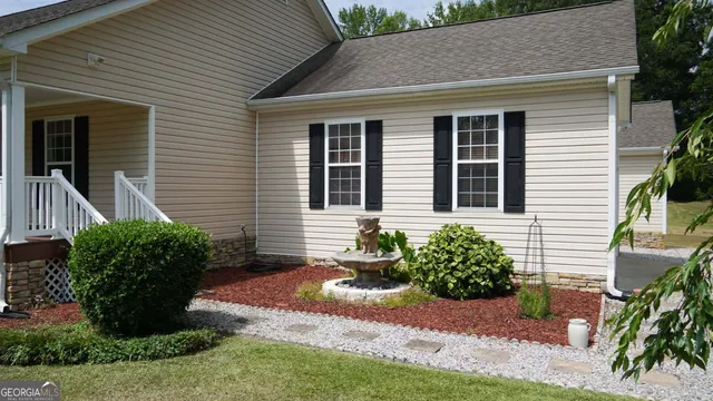 a front view of a house with garden