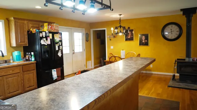 a kitchen with a refrigerator and a stove top oven