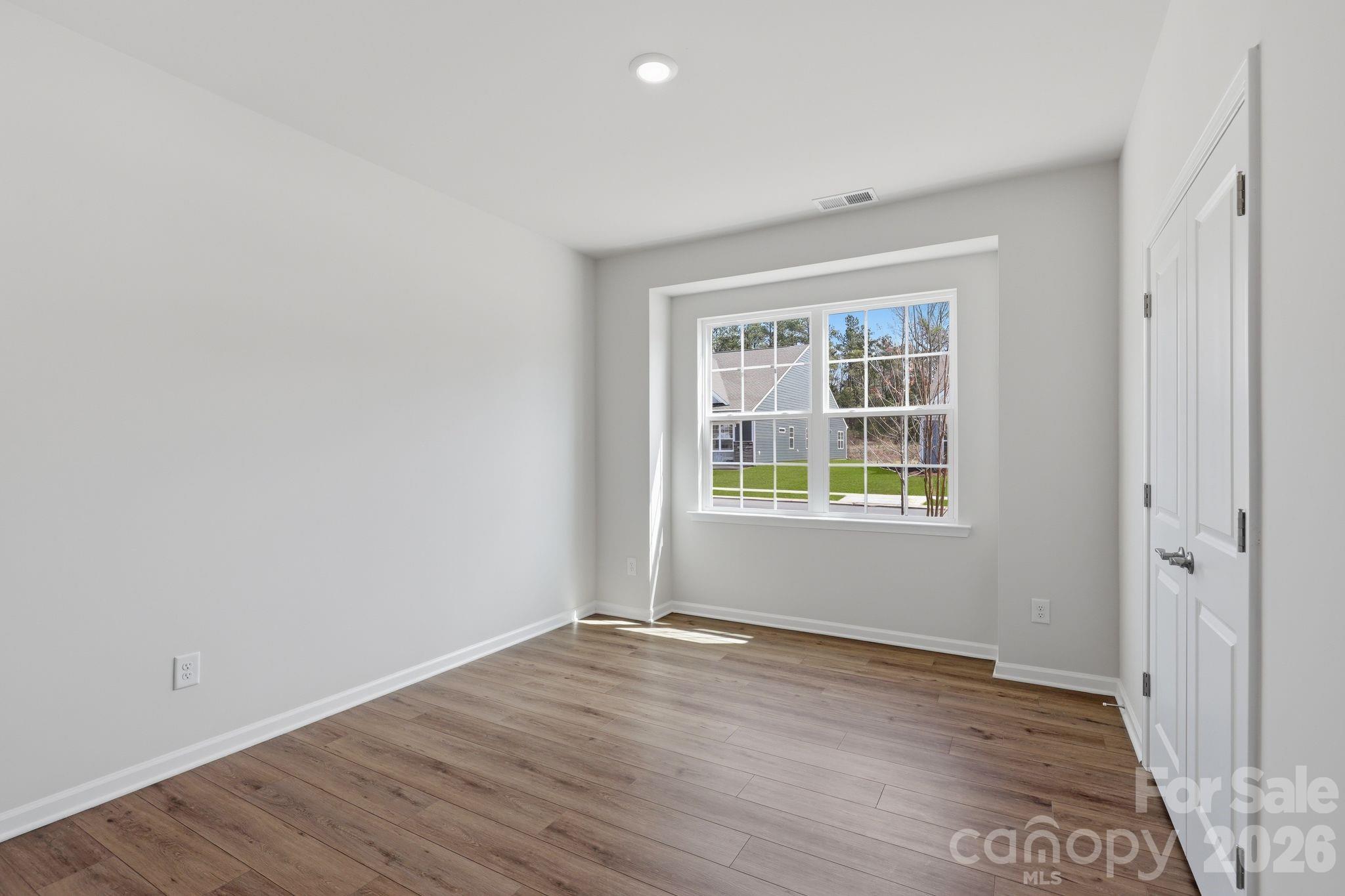 5475 Redbud Road, Unit 57 Lancaster, SC 29720 - Photo 20 of 30 an empty room with wooden floor and windows