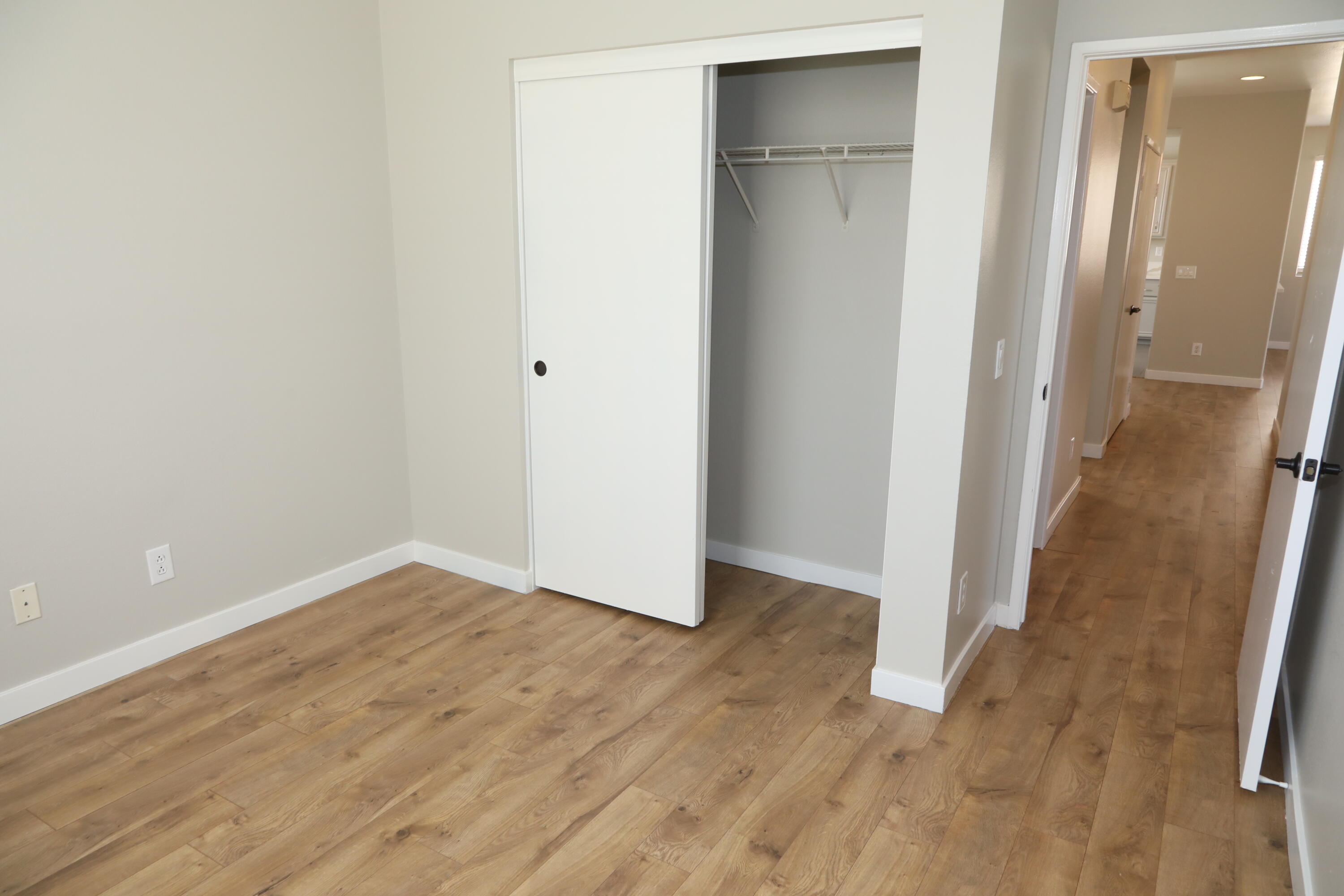 1559 Ave H4 Lancaster, CA 93534 - Photo 12 of 16 a view of an empty room with wooden floor