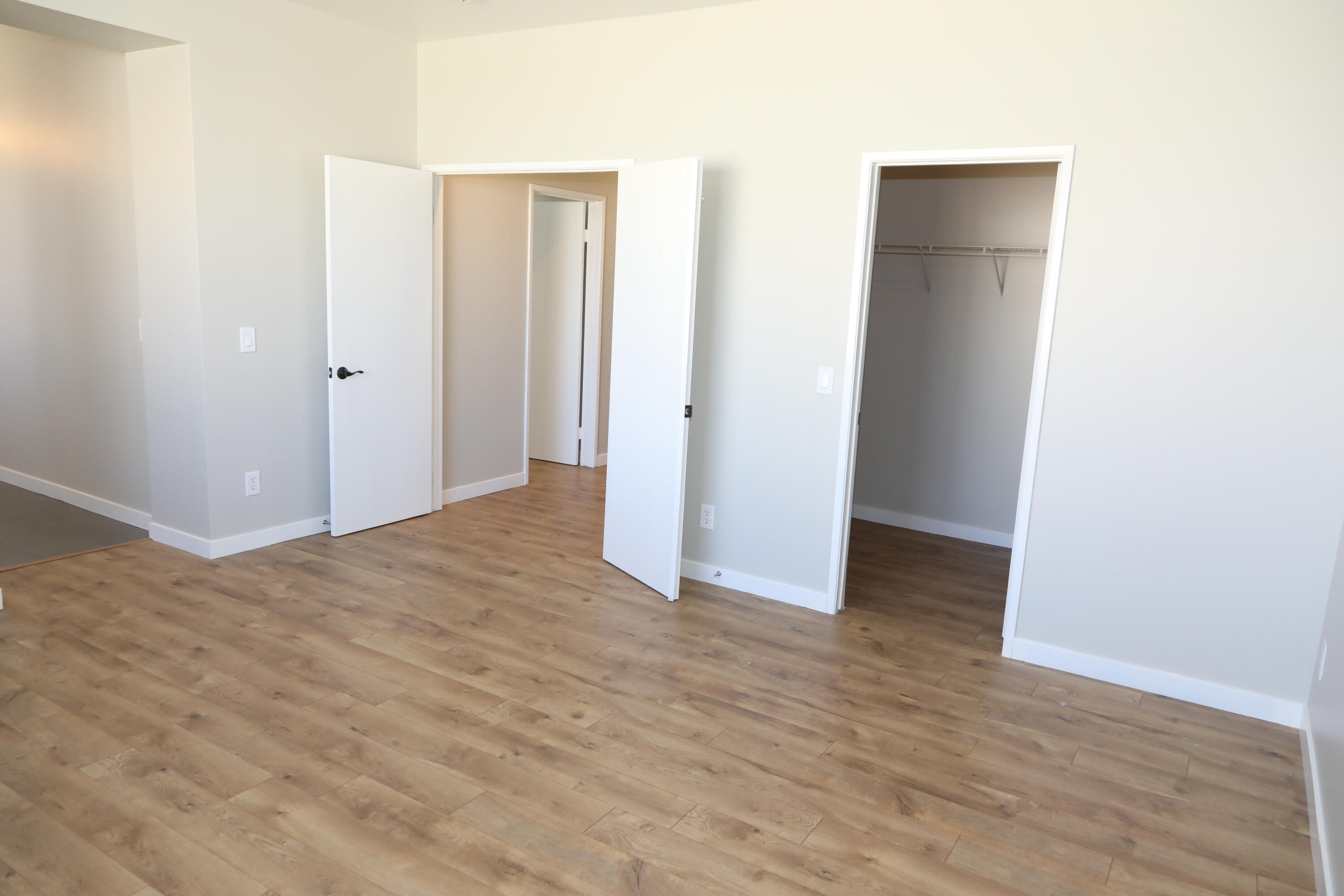 1559 Ave H4 Lancaster, CA 93534 - Photo 13 of 16 a view of an empty room with wooden floor
