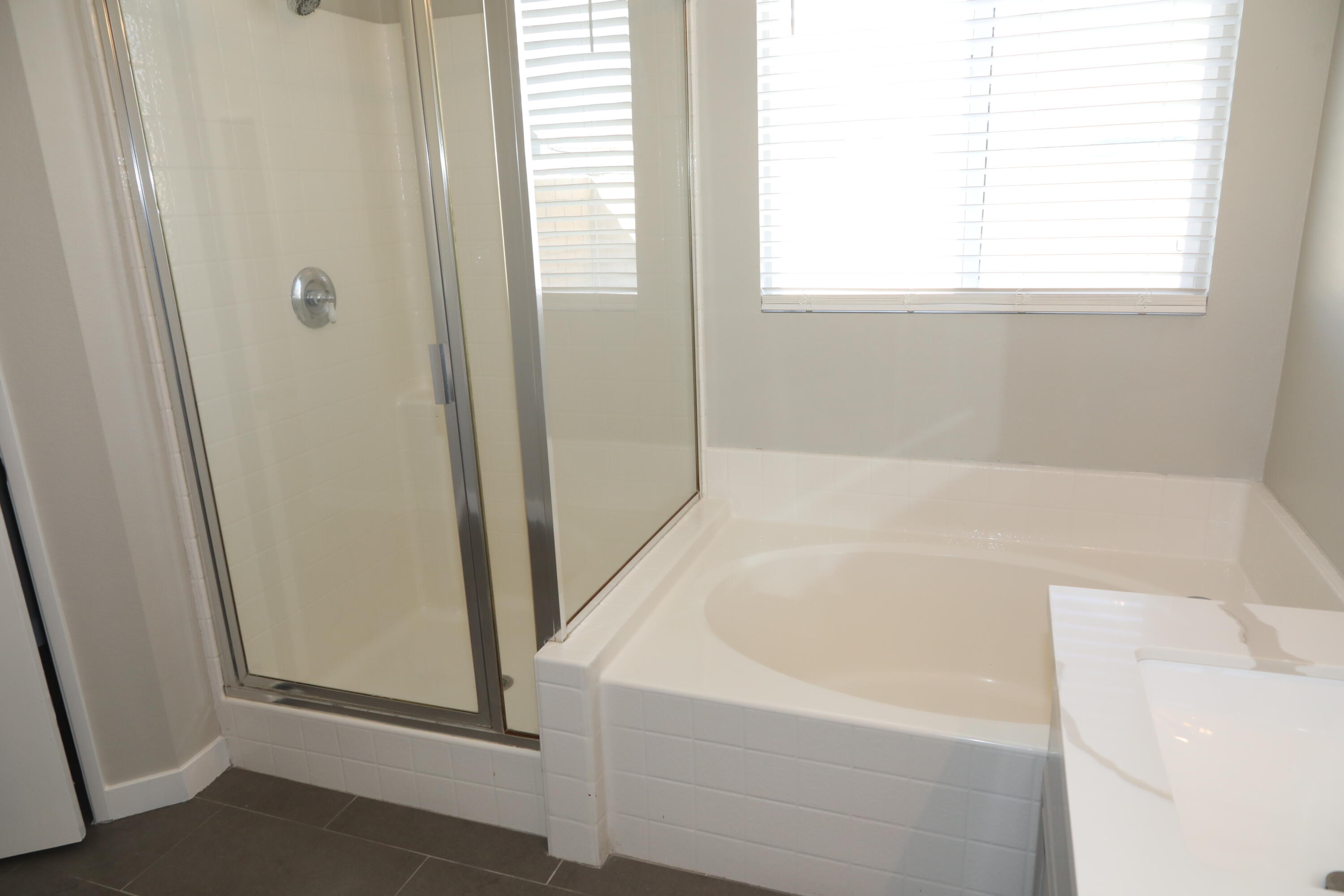 1559 Ave H4 Lancaster, CA 93534 - Photo 16 of 16 a bathroom with bathtub and window