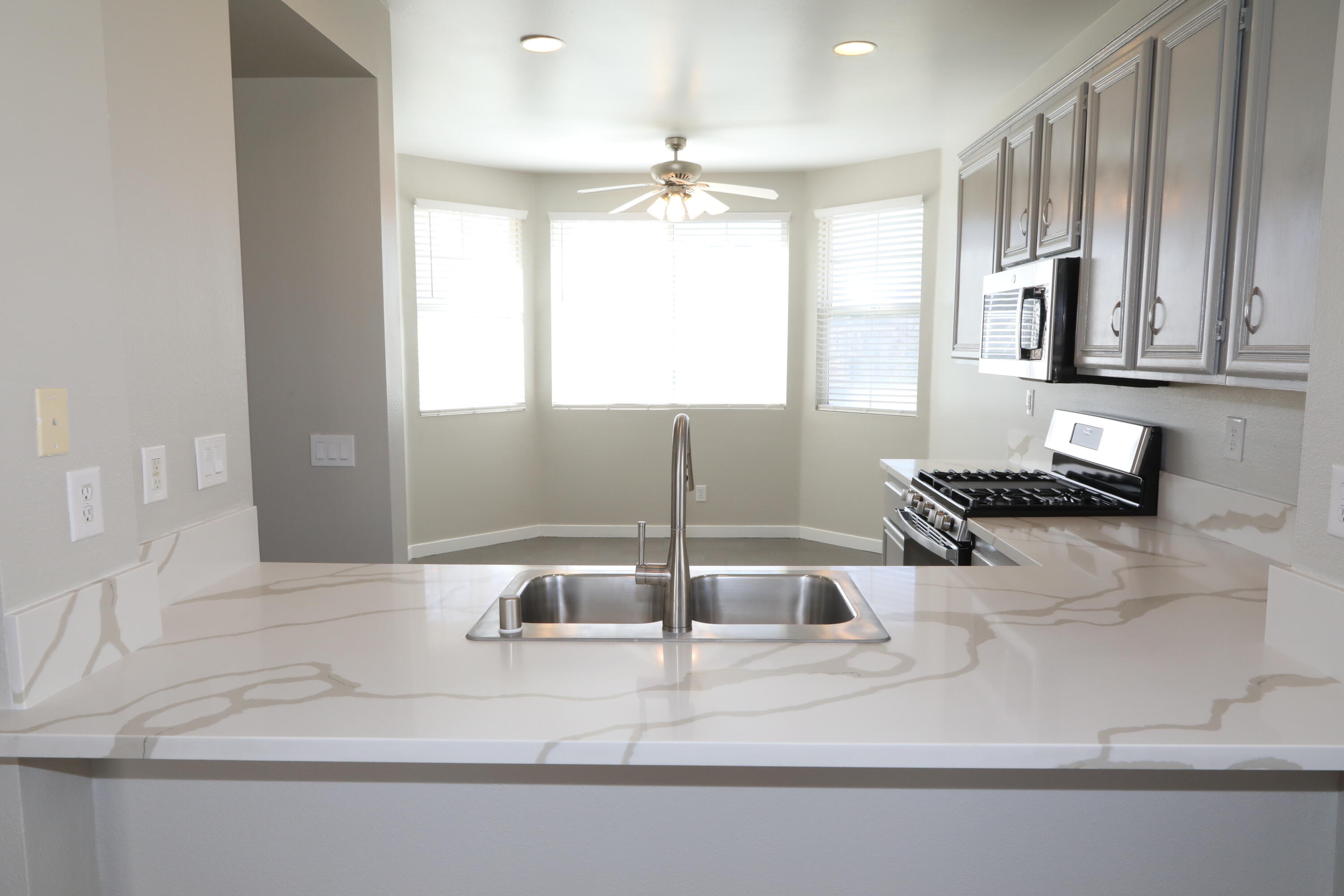 1559 Ave H4 Lancaster, CA 93534 - Photo 7 of 16 a kitchen with a sink cabinets and window
