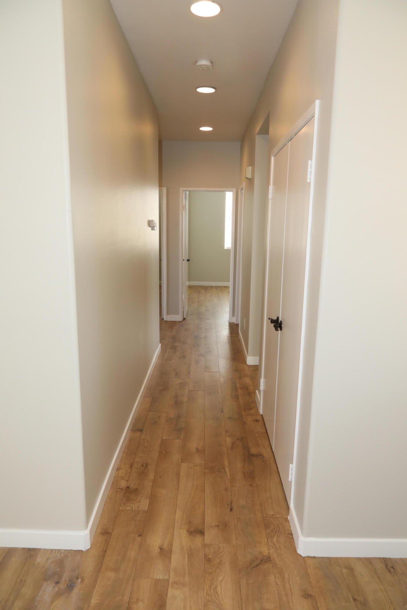 1559 Ave H4 Lancaster, CA 93534 - Photo 8 of 16 a view of a hallway with wooden floor