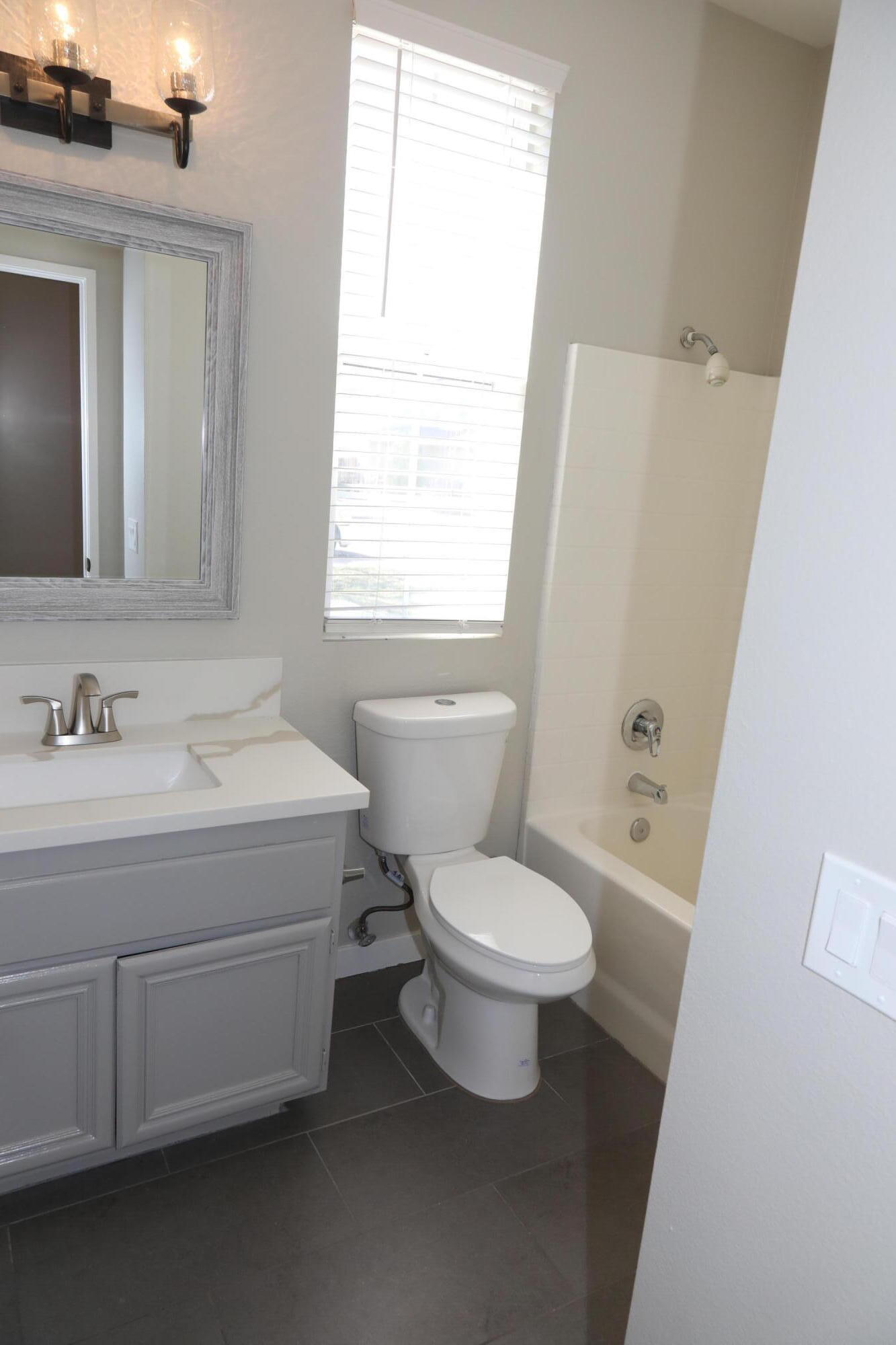 1559 Ave H4 Lancaster, CA 93534 - Photo 9 of 16 a bathroom with a sink toilet and vanity