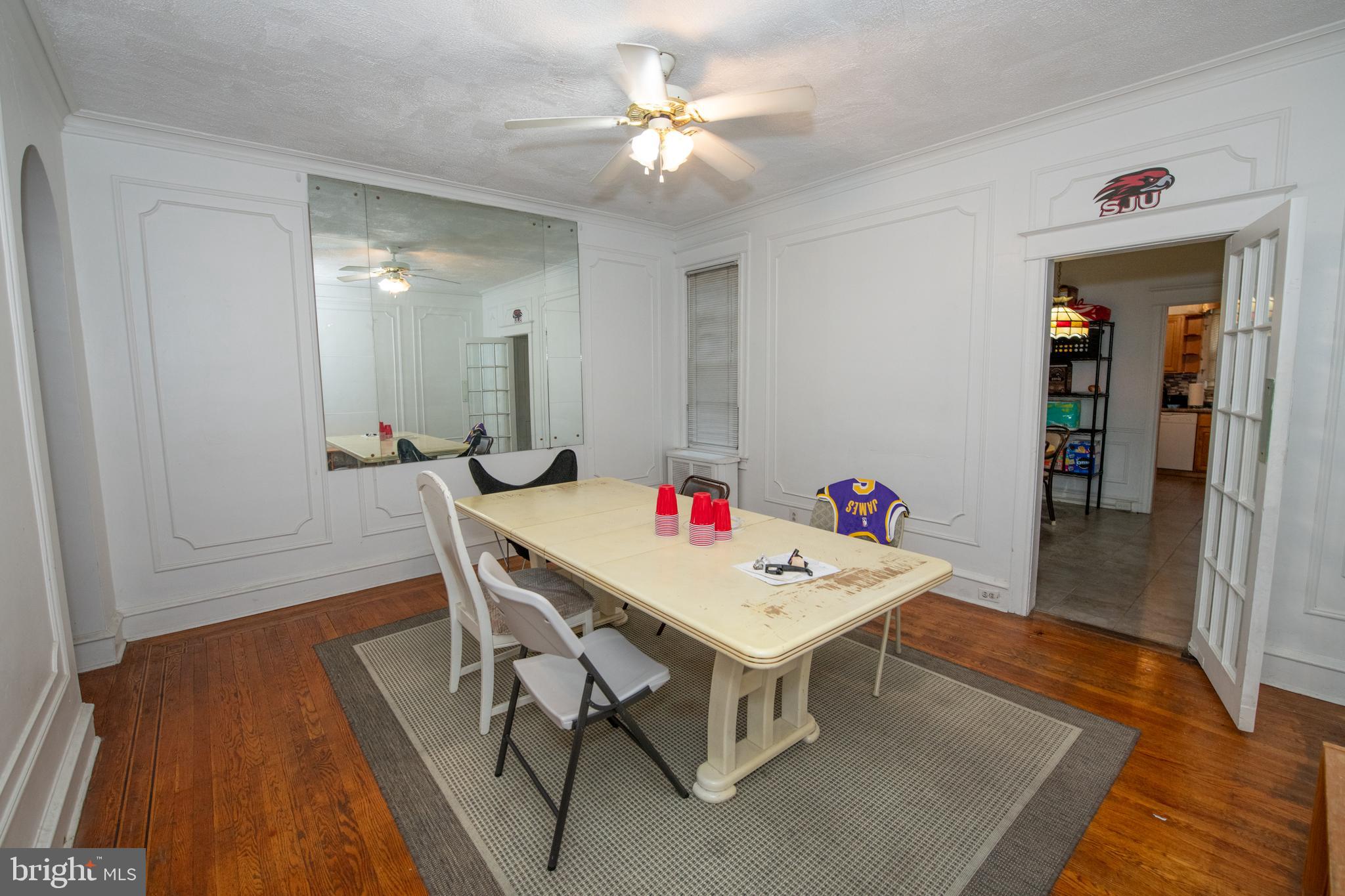 5608 Woodbine Avenue Philadelphia, PA 19131 - Photo 14 of 44 a view of a dining room with furniture and wooden floor