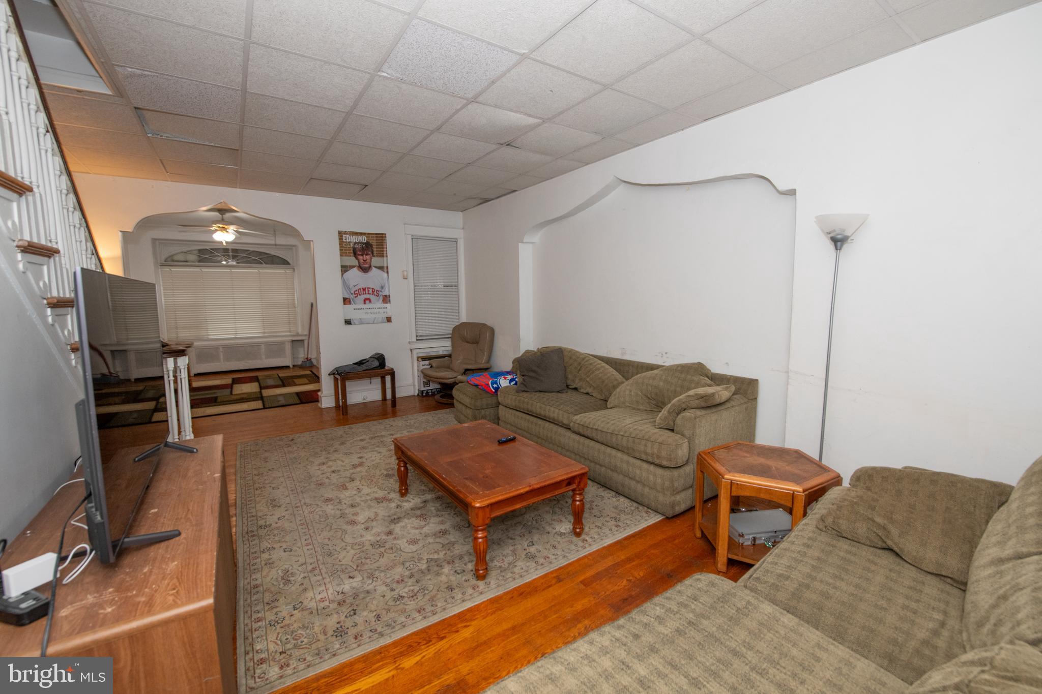5608 Woodbine Avenue Philadelphia, PA 19131 - Photo 15 of 44 a living room with furniture a wooden floor and a sink