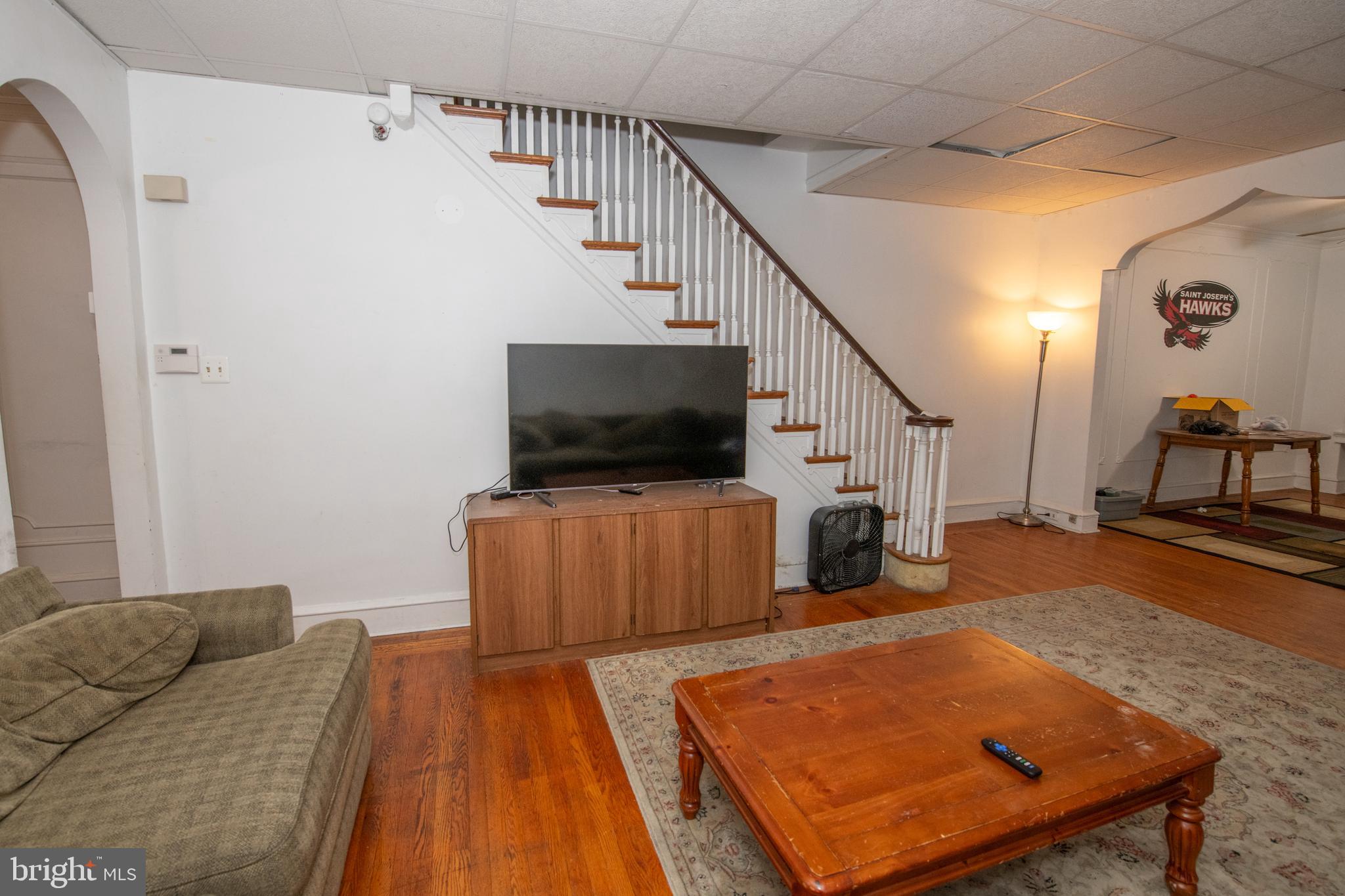 5608 Woodbine Avenue Philadelphia, PA 19131 - Photo 16 of 44 a living room with furniture and a flat screen tv