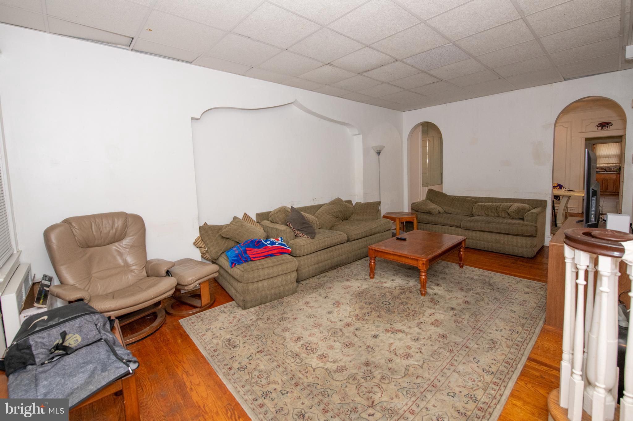 5608 Woodbine Avenue Philadelphia, PA 19131 - Photo 18 of 44 a living room with furniture and a rug