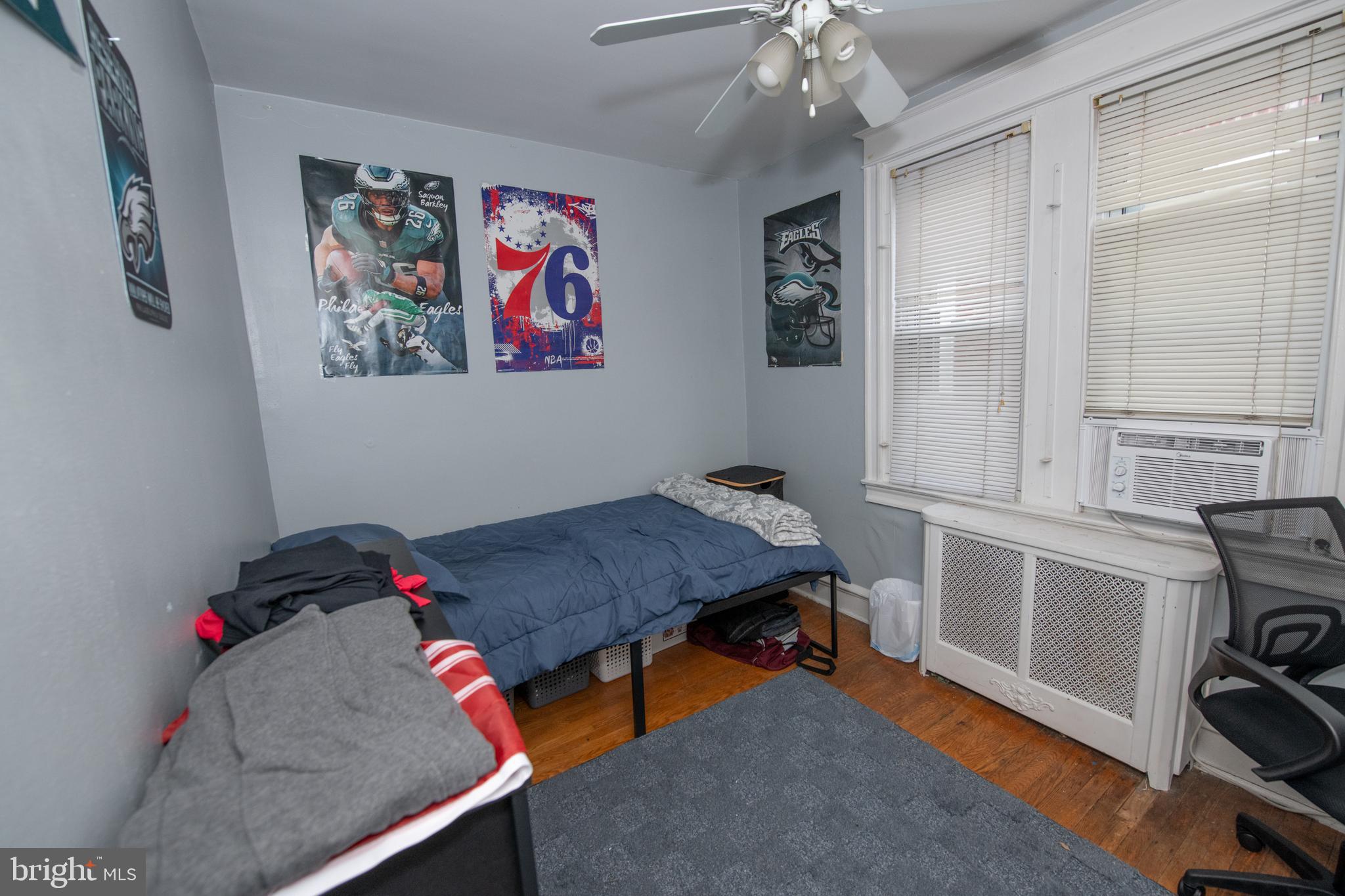 5608 Woodbine Avenue Philadelphia, PA 19131 - Photo 39 of 44 a bedroom with a bed and a chandelier
