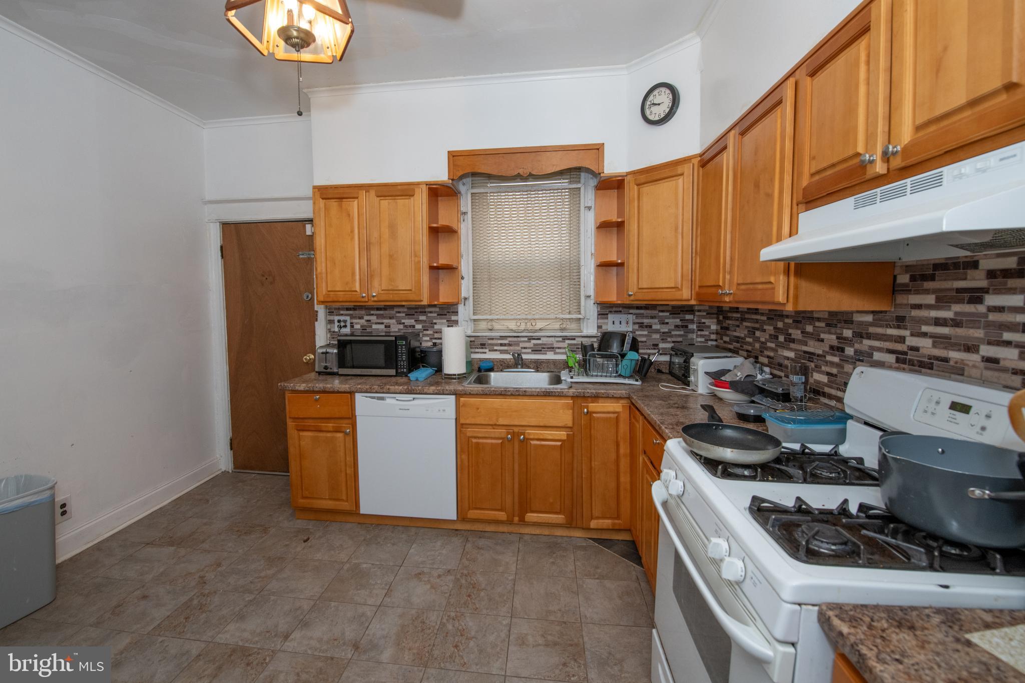 5608 Woodbine Avenue Philadelphia, PA 19131 - Photo 6 of 44 a kitchen with stainless steel appliances a stove a sink and cabinets