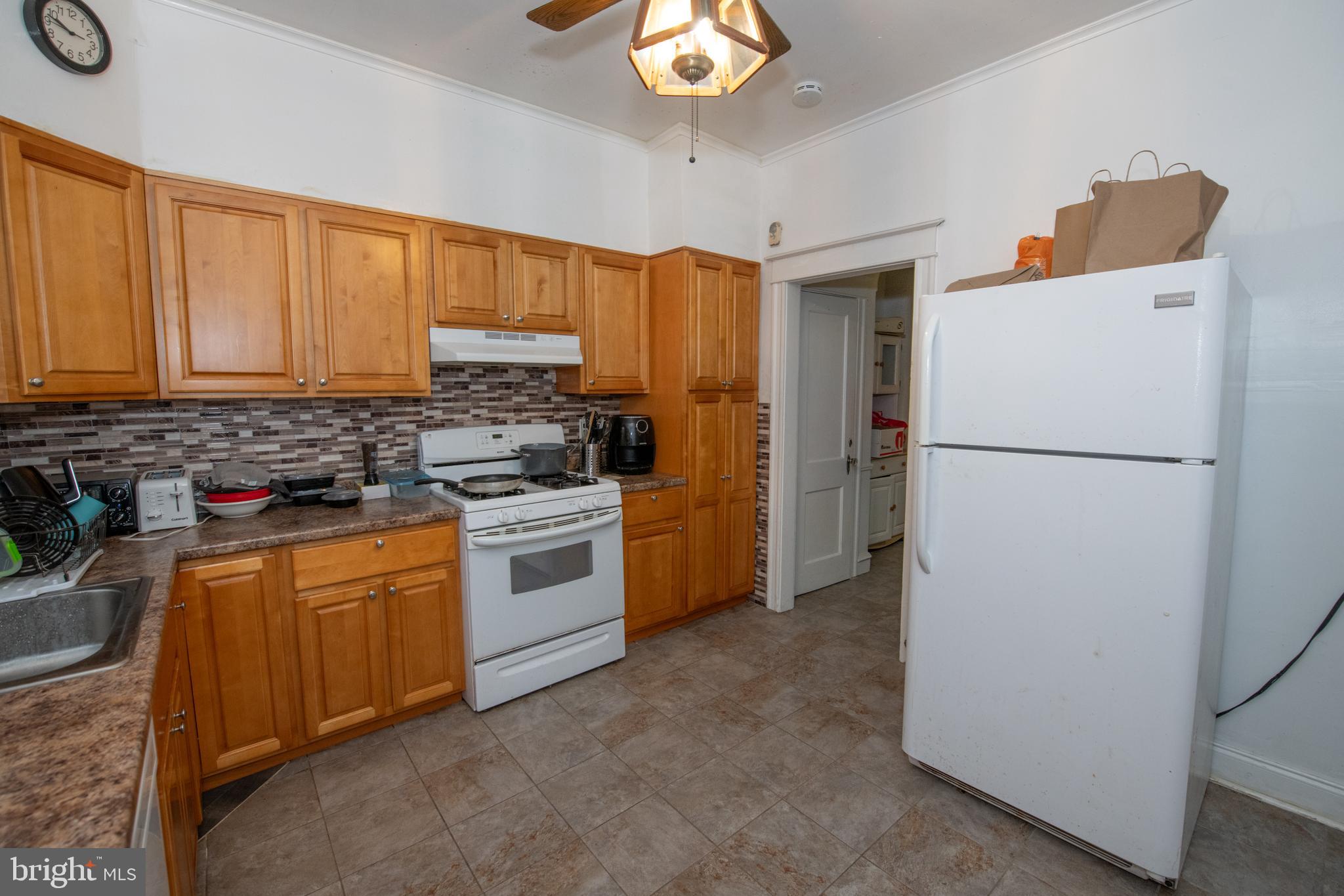 5608 Woodbine Avenue Philadelphia, PA 19131 - Photo 7 of 44 a kitchen with a refrigerator sink and cabinets