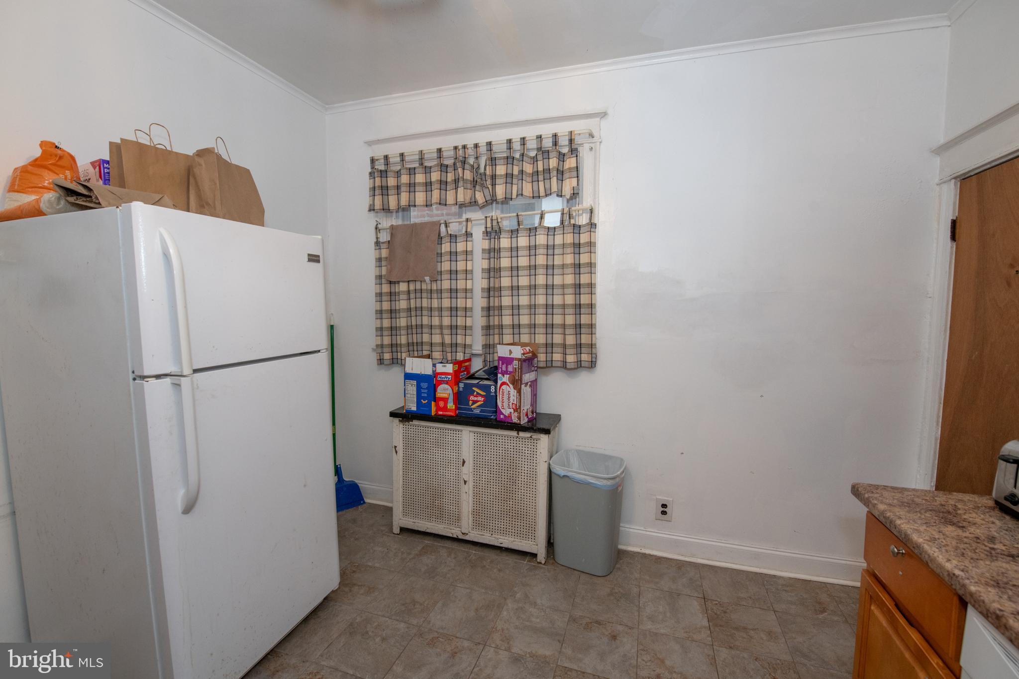 5608 Woodbine Avenue Philadelphia, PA 19131 - Photo 8 of 44 a kitchen with stainless steel appliances a refrigerator and a stove
