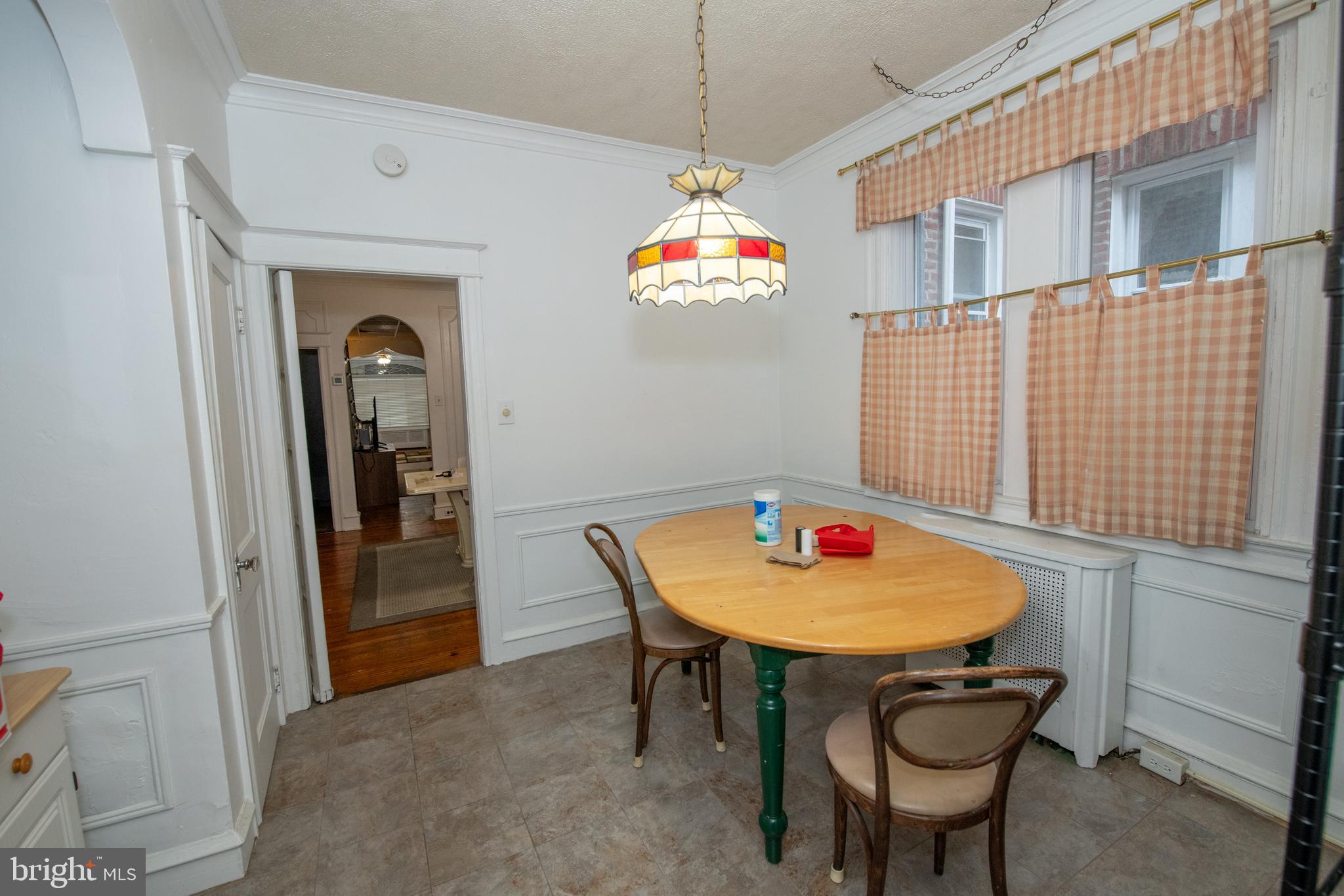 5608 Woodbine Avenue Philadelphia, PA 19131 - Photo 9 of 44 a dining room with furniture and a chandelier