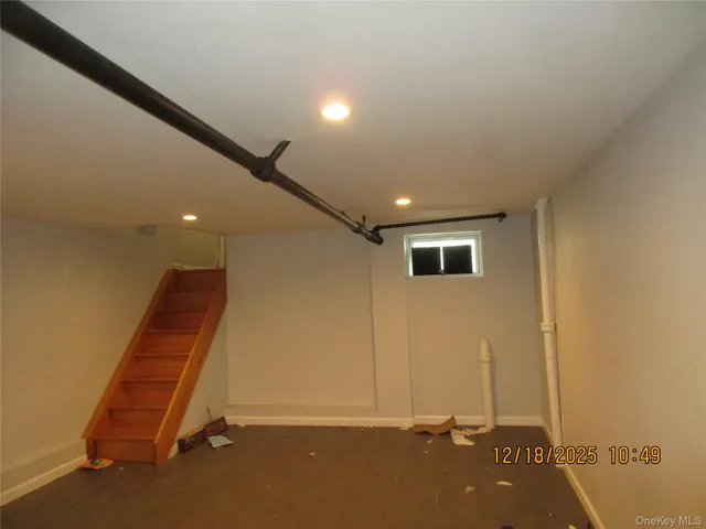 an empty room with wooden floor and entrance