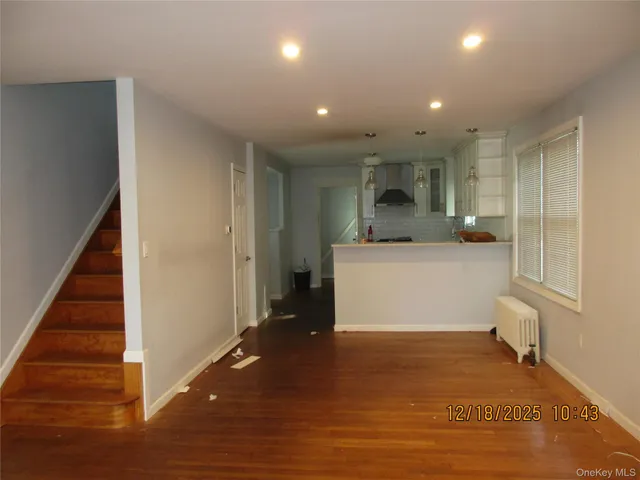 a view of a hallway with kitchen and entryway