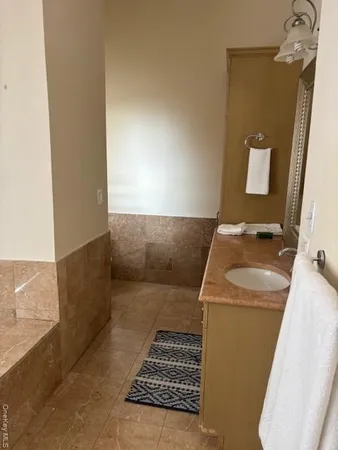 a bath tub sitting next to a bathroom sink