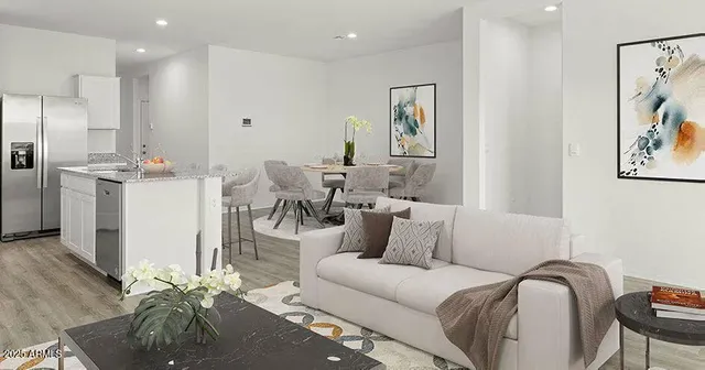 a living room with furniture and a wooden floor