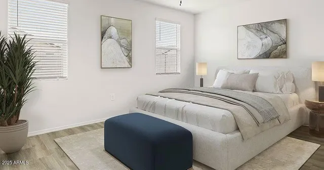 a bedroom with a bed and a potted plant